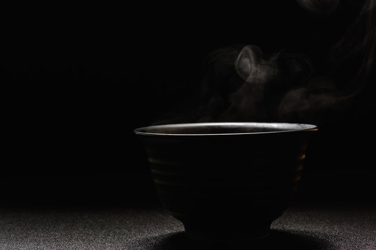 Soup Hot In Black Bowl On Wooden Table,food Steam And Copy Space ,selective Focus.Fresh Foods Concept