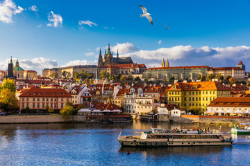 Prague Castle, Charles Bridge and boats on the Vltava river. View of Hradcany Prague Castle,...