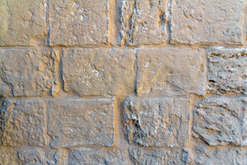 Light yellow stone wall of bricks texture background