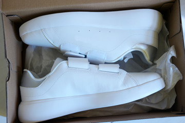 White new casual sport shoes on the floor