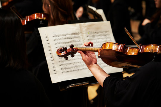 Playing the violin in orchestra 