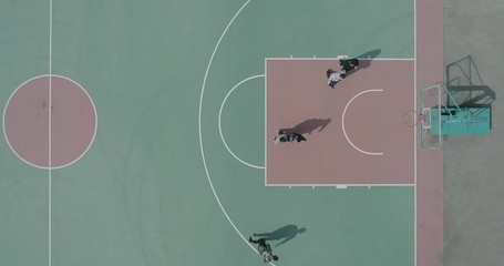 Unmanned top view of people playing basketball on the outdoor basketball court - Powered by Adobe