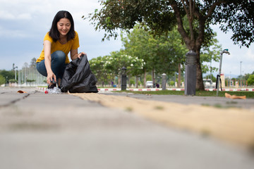 Fototapeta premium environment protection pollution problems and global warming,plastic waste caring about nature concept.Volunteer women carrying garbage bags, garbage collection, cleaning in the national park