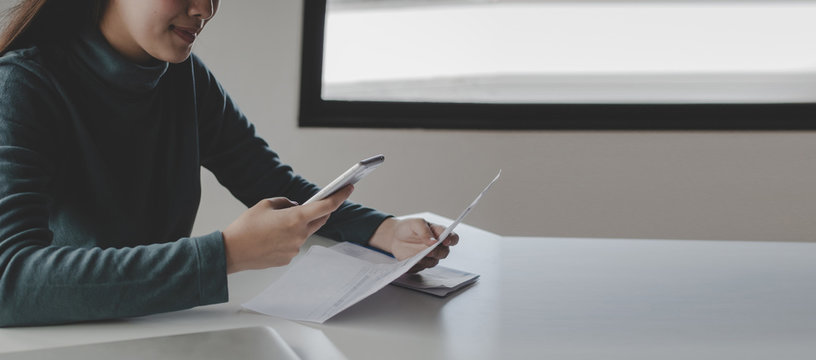 Panoramic Banner. Young Woman Using Mobile Smart Phone For Scan And Payment Online With Family Budget Cost Bills On Desk In Home Office, Plan Money Cost Saving, Investment, Finance, Expenses Concept