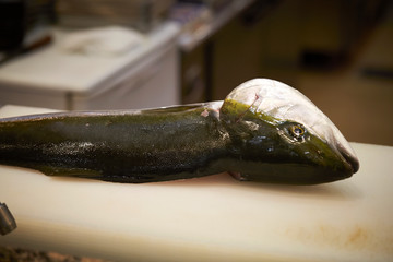 Filleting fish at fish market 