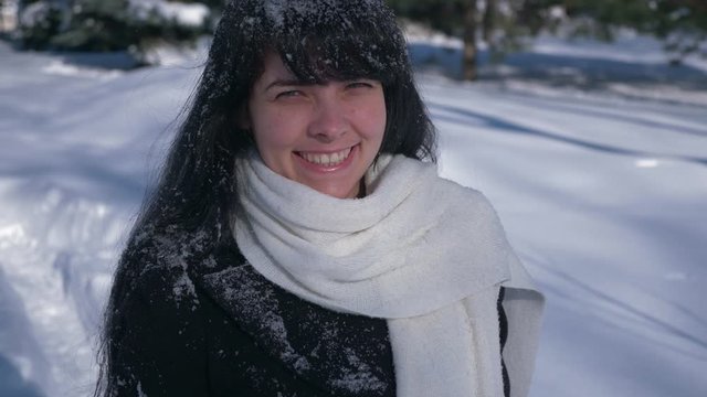 4K 60p Portrait Pretty Smiling Girl In Snow Covered Park. Winter Holidays. Bright Sunny Snowy Day In City