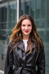Fototapeta premium Portrait of a Young Woman in Black Trench Coat