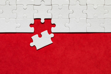 Closeup of jigsaw puzzle isolated. Missing jigsaw puzzle piece, business concept for completing the...