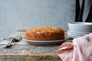Homemade apple crumble pie on the plate. Gray background