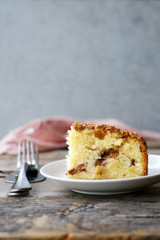 Homemade apple crumble pie on the plate. Gray background