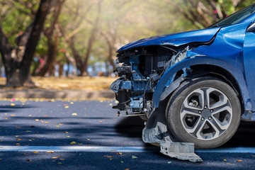 Front of blue color car big damaged and broken by accident on city street parking can not drive any more. With copy space for text or design