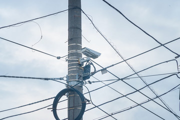 Outdoor surveillance camera on pole with cables