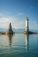 Fototapeta na wymiar Harbour entrance of Lindau, Lake Constance - Germ. - Bodensee - with the new lighthouse and the Bavarian Lion. The Lindau lighthouse is the southernmost lighthouse in Germany