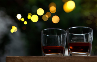 a glass of whiskey on wood bar, soft focus.