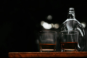 whisky shot glass at bar counter.	