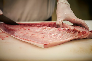 Filleting fish at fish market 