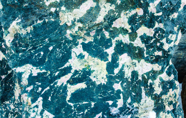 The surface of the gabbro stone is close, macro.