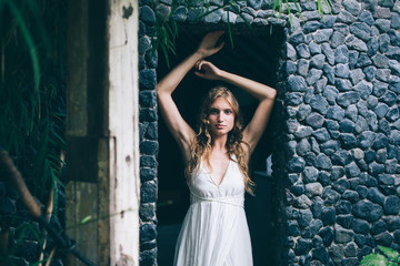 Obraz premium Young pensive woman standing in doorway
