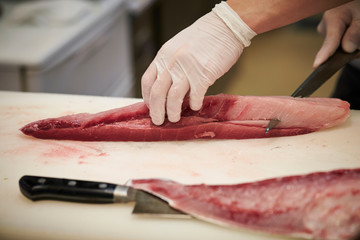 Filleting fish at fish market 
