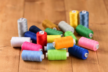 Cotton thread bobbins on wooden table
