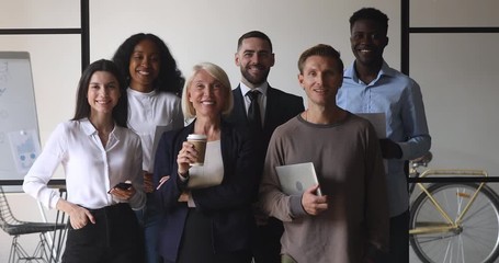Happy multiracial business people stand together in office, team portrait