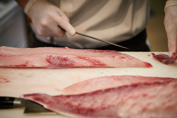 Filleting fish at fish market 