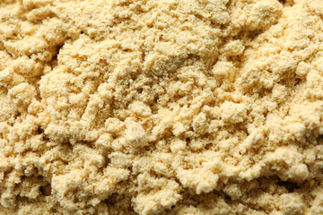 Ginger powder texture background, macro. Wallpaper for design