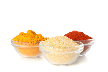 Bowls with garlic, curry and red pepper powder isolated on white background