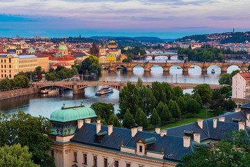 Prague, Czech Republic bridges panorama with historic Charles Bridge and Vltava river at night....