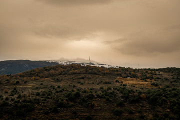 The mountains of Lebanon were once shaded by thick cedar forests and tree is the symbol of country. Beautiful landscape of mountainous town in winter, Eco tourism, Chouf district  with large vistas