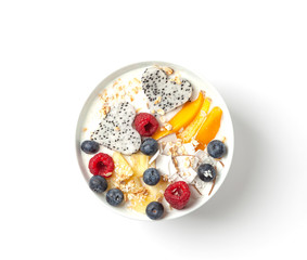 Smoothie bowl with mango, pineapple, dragon fruit, blueberries, raspberries and coconut. Delicious and healthy Breakfast.