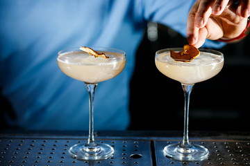 The bartender prepares a cocktail on the bar.