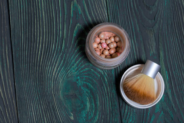 Makeup kit. Lies on brushed pine boards painted in black and green.