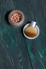 Makeup kit. Lies on brushed pine boards painted in black and green.