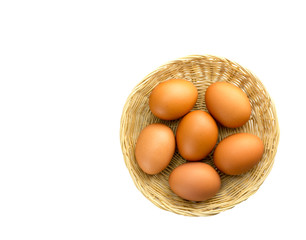 Eggs placed in a woven wooden basket.