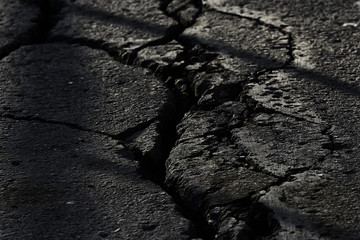 asphalt in cracks texture / abstract background cracks on asphalt road