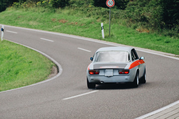 Blur background old vinatge retro european race car on the road back view