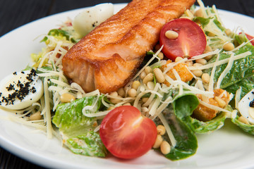 Grilled salmon caesar salad with croutons, parmesan, pine nut and quail egg