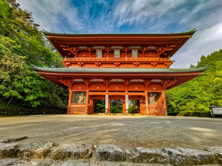 The vibrant red Daimon gate functioning as the entrance to the famous pilgrimage town Koyasan in Wakayama, Kansai, Japan.