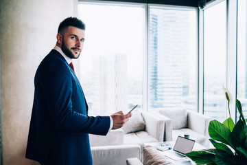 Contemporary employee using device at office