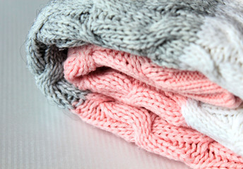 Fototapeta na wymiar One folded grey and pink warm knitted sweater
