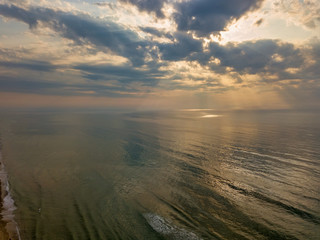 Aerial view of a Sunrise sky background. Aerial Dramatic gold sunrise with morning sky clouds over the sea. Stunning sky clouds in the sunrise. Aerial photography.