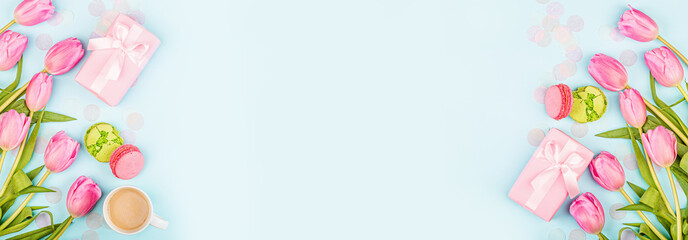 View from above tulips and gift box with copy space on blue. Background for womens day, 8 March Valentines day, 14 february. Flat lay style, top view, mockup, template, overhead. Greeting card