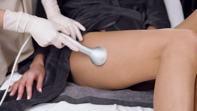 Close up of cosmetology procedure of anti cellulite massage for legs in spa salon