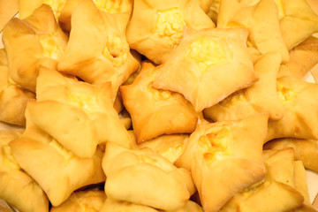 Closeup traditional Asian cuisine – homemade star-shaped pastry filled with curd or cottage cheese (selective focus)