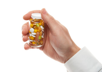 Man hand with glass bottle full of pills, tablets, vitamins, drugs, capsules isolated on white background. White shirt, business style. Health care concept. Pharmaceutical industry. Pharmacy.