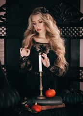 Stock Photo - beautiful young witch  girl. Halloween girl in black