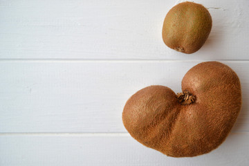 The ugly fruit, odd kiwi. Tasty and healthy. Vegetarian food. On a white background with copyspace.