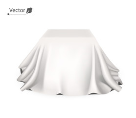 Box covered with white silk cloth. Empty podium, stand with tablecloth to show magic tricks. Secret gift, hidden under satin fabric with drapery and folds.