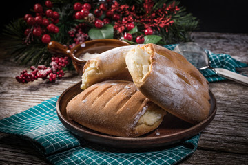 Sweet buns with cheese on wooden table.